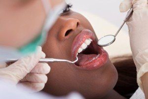 Dentist giving female dental patient a choice of traditional or white filling