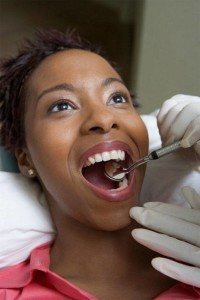 Female dental patient having affordable examination and teeth cleaning
