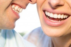 Man and woman with straight even teeth after affordable dental veneers