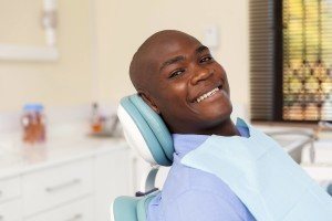 Relieved dental patient after a comprehensive dental implant treatments that he can afford