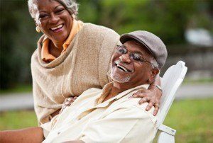 Senior couple smiling after getting their inexpensive dentures